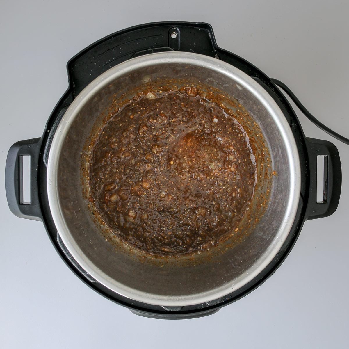 salsa spices and onions in pressure cooker.