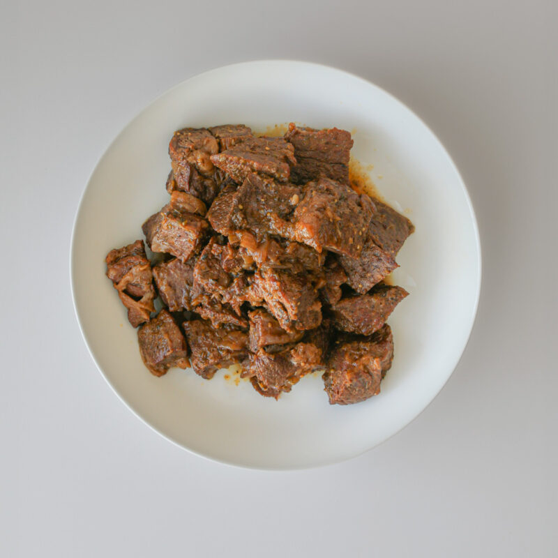 meat cubes in a white bowl.