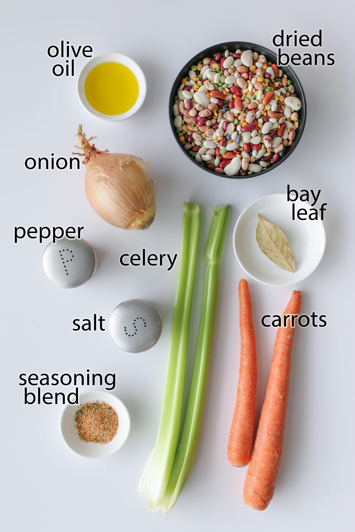 ingredients for instant pot bean soup laid out on a white table.