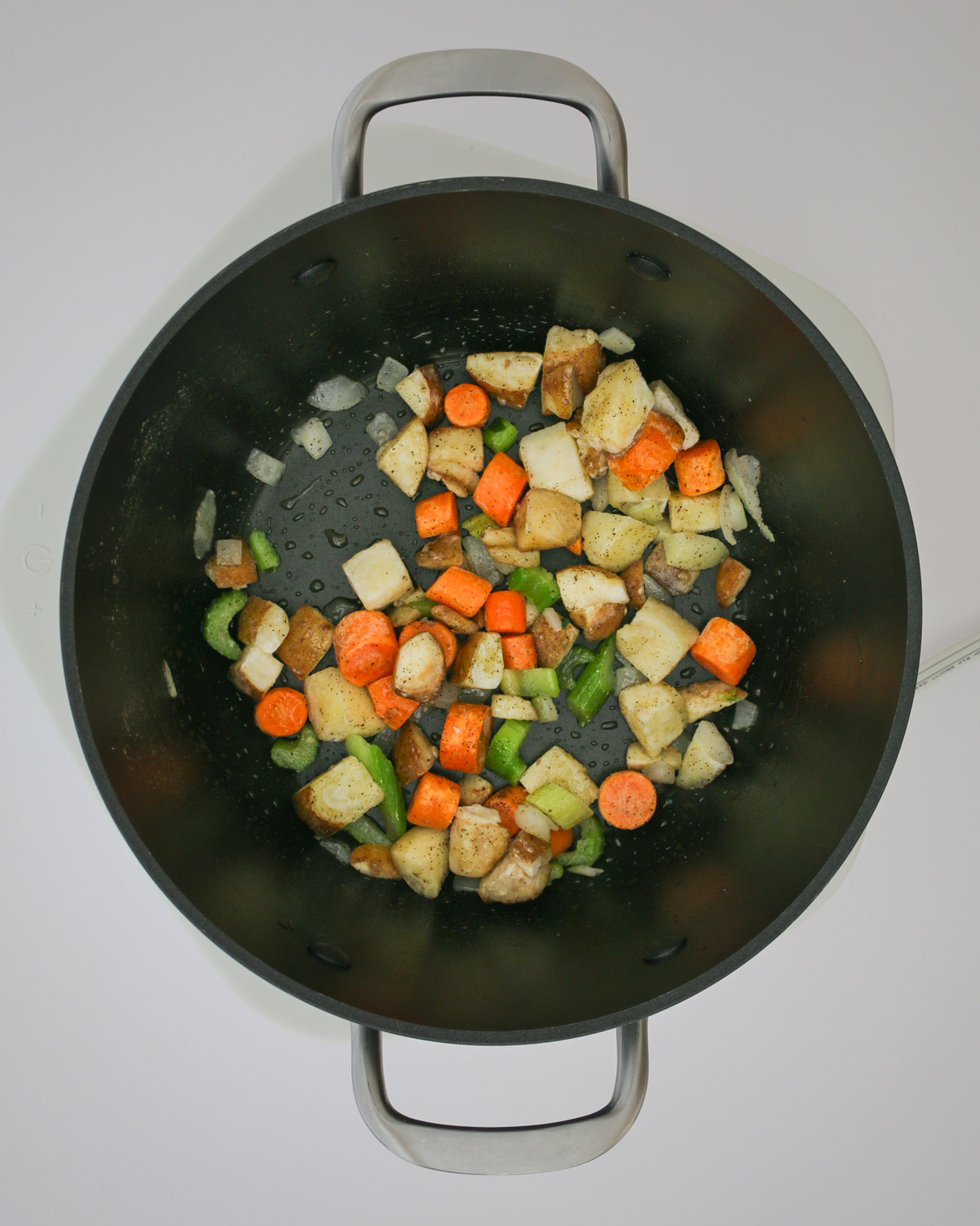 sauteing vegetables in a large soup pot.