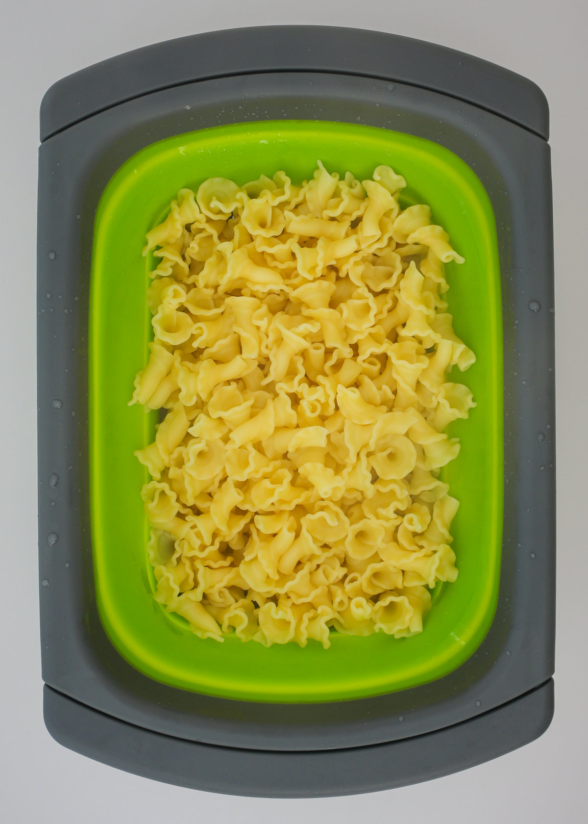 cooked and drained pasta in a collander.