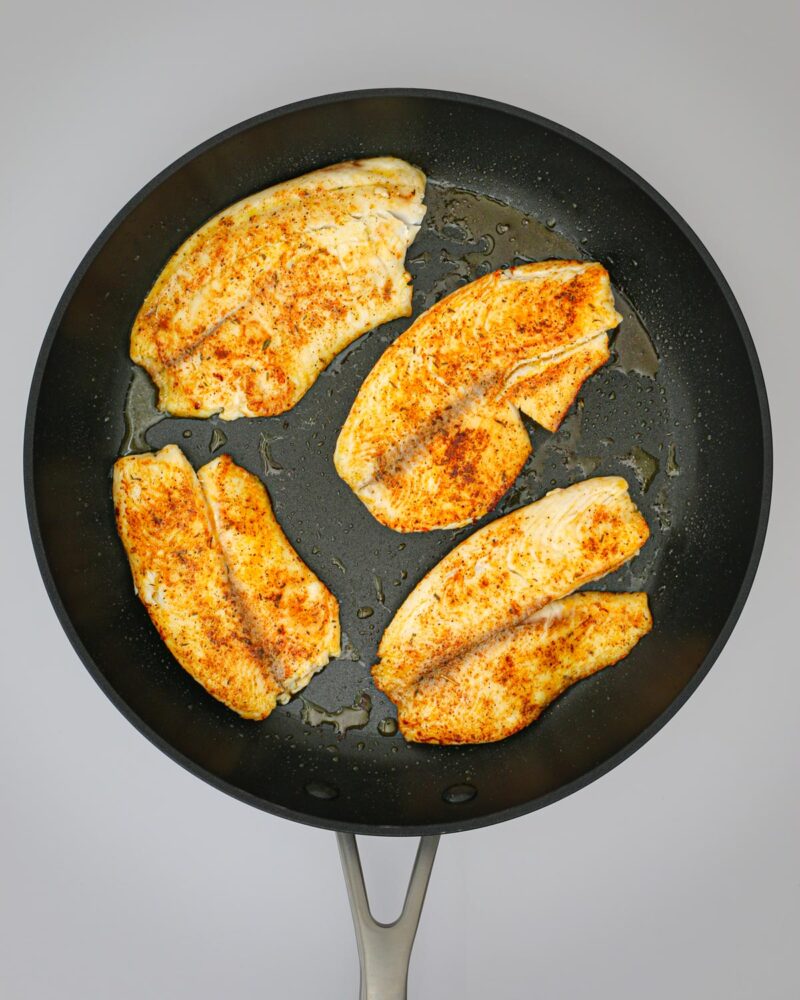 cooked fish in a skillet.