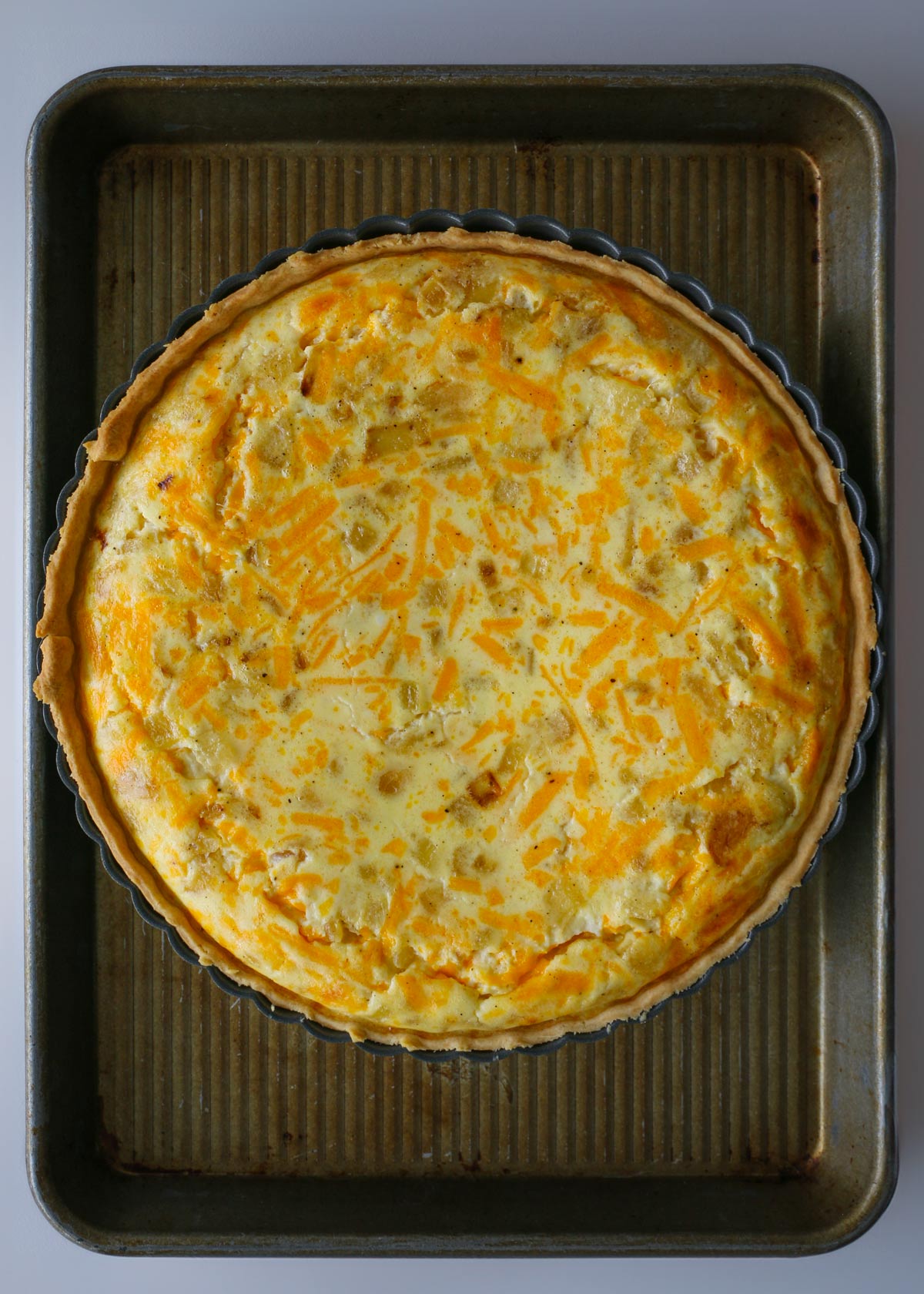 baked cottage cheese quiche on tray.