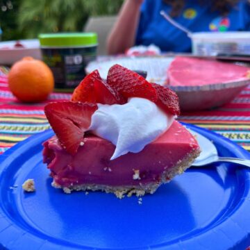strawberry jello pie on blue paper plate.