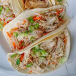 close up overhead shot of moo shu chicken in tortillas.