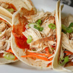 close up of moo shu chicken in tortillas.