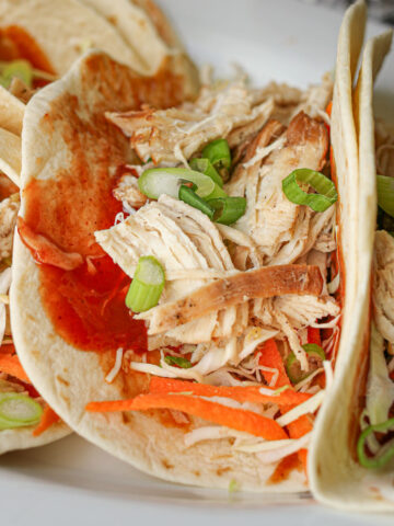 close up of moo shu chicken in tortillas.