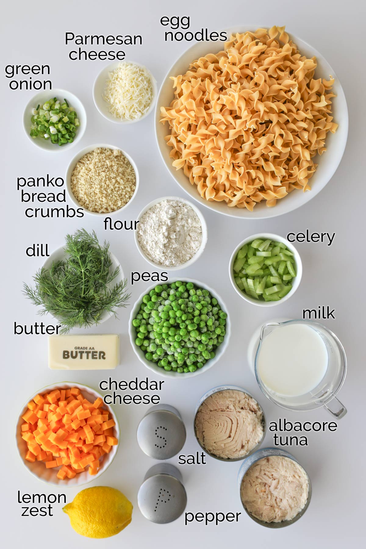 ingredients needed to make tuna noodle casserole laid out on a white counter.