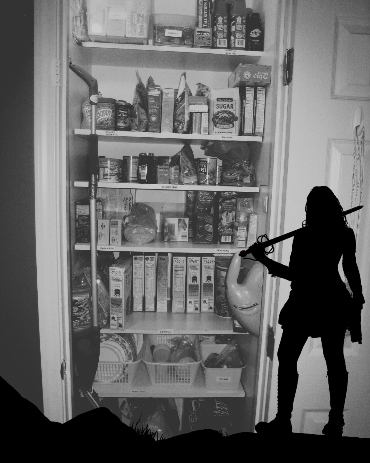 bw image of pantry with silhouette of a female warrior in front of it.