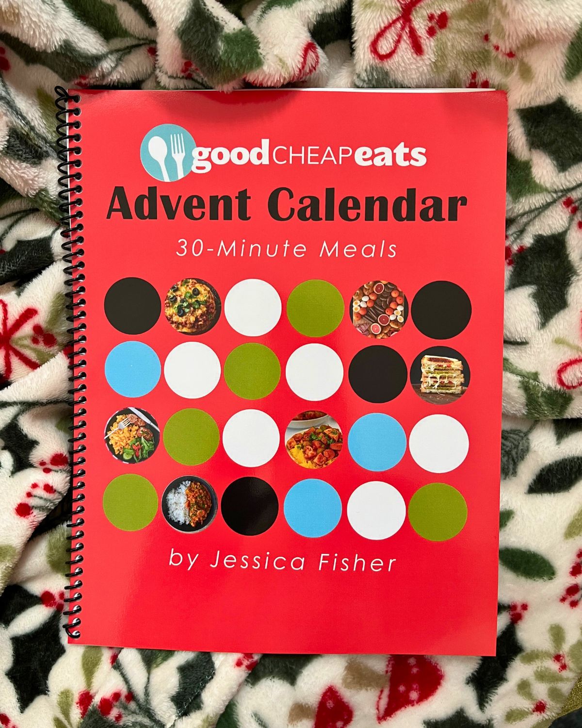 meal plan advent calendar printed and spiral bound, sitting on a blanket.
