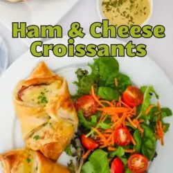 plate of salad and ham and cheese croissants, with text overlay.