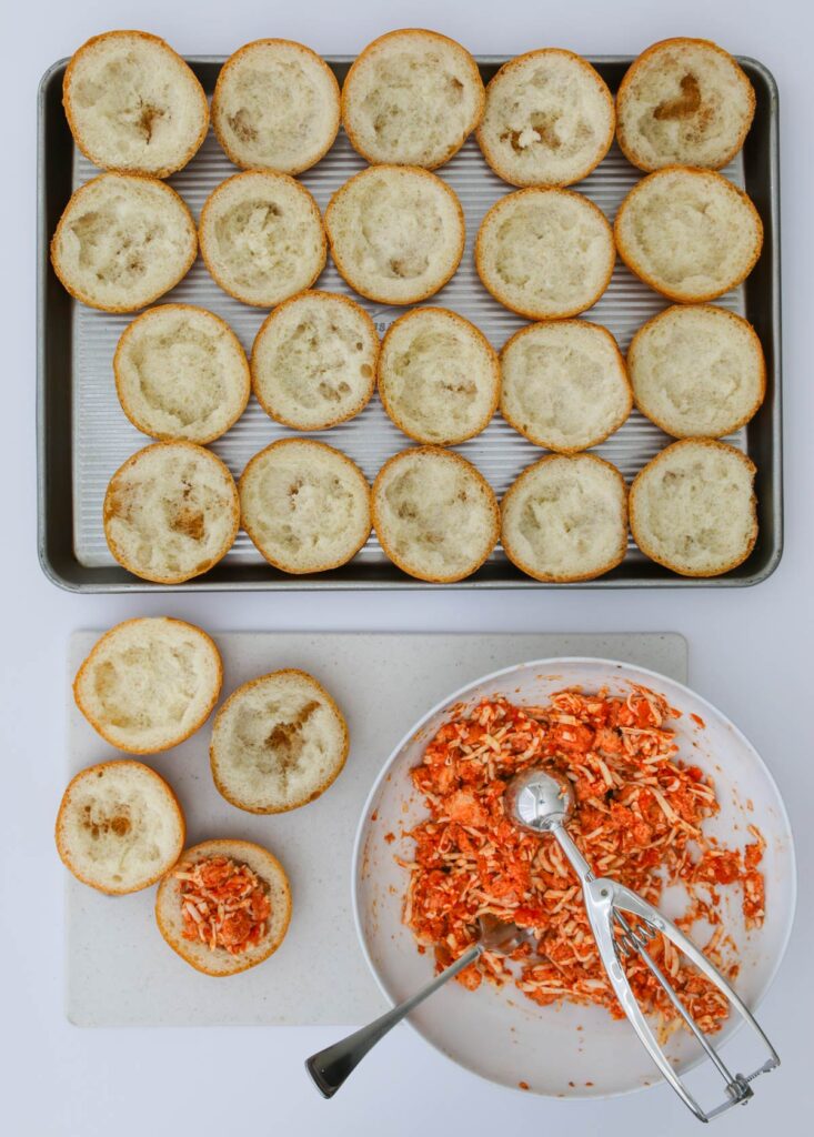 stuffing the bread shells with filling.