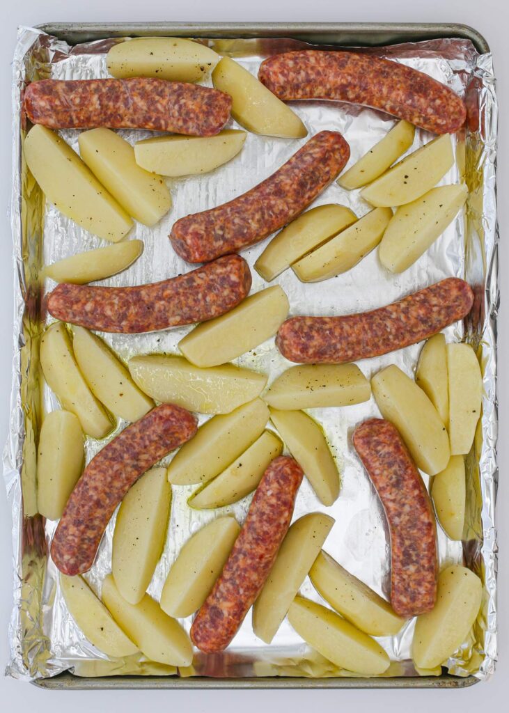 potatoes and sausage on baking sheet.