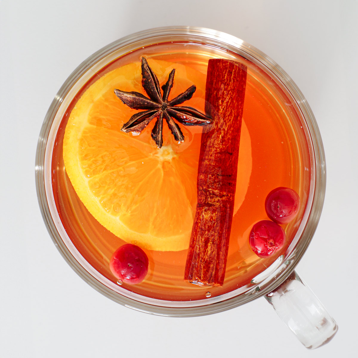 overhead shot of wassail punch with garnishes.