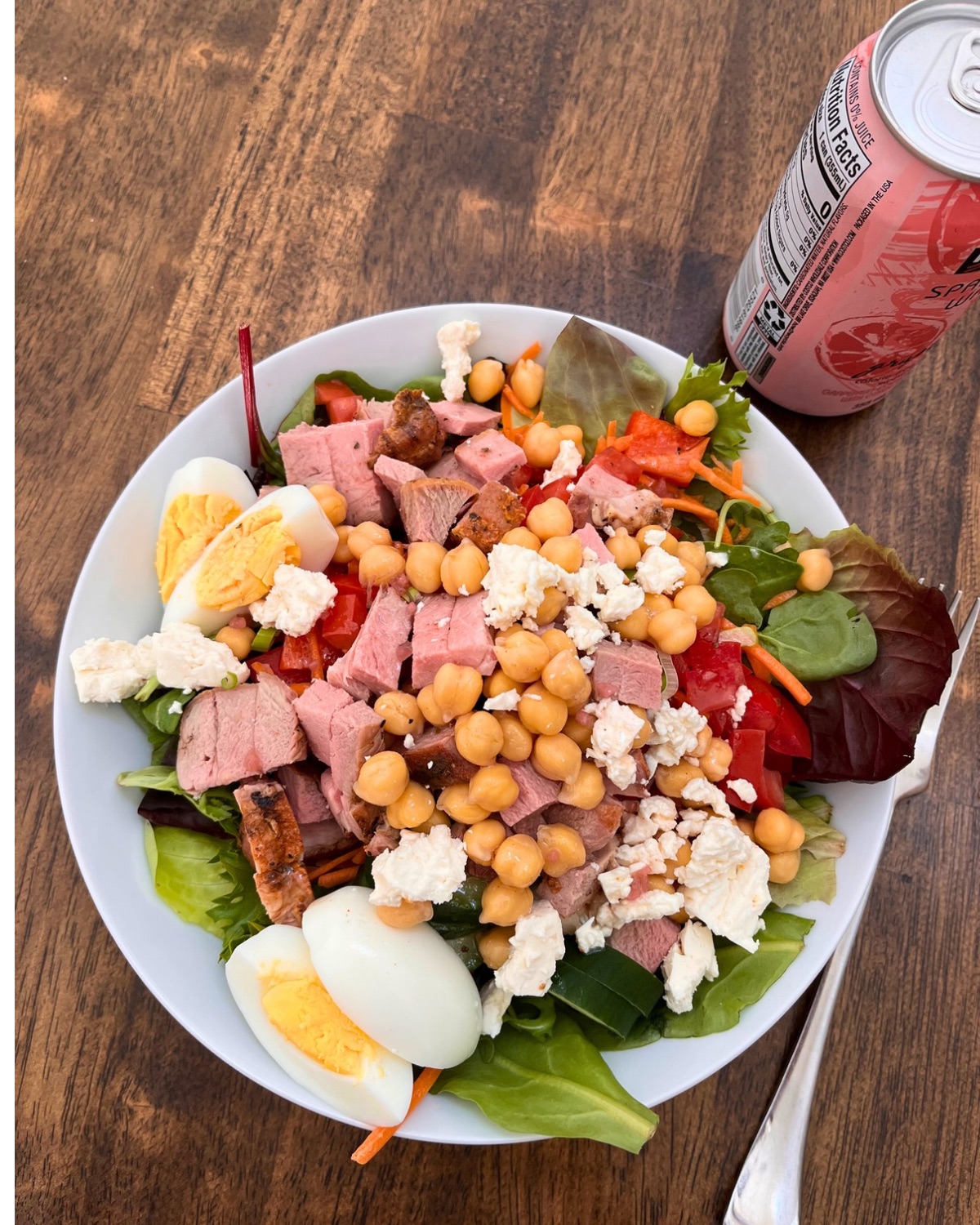 large lunch salad on wooden table.