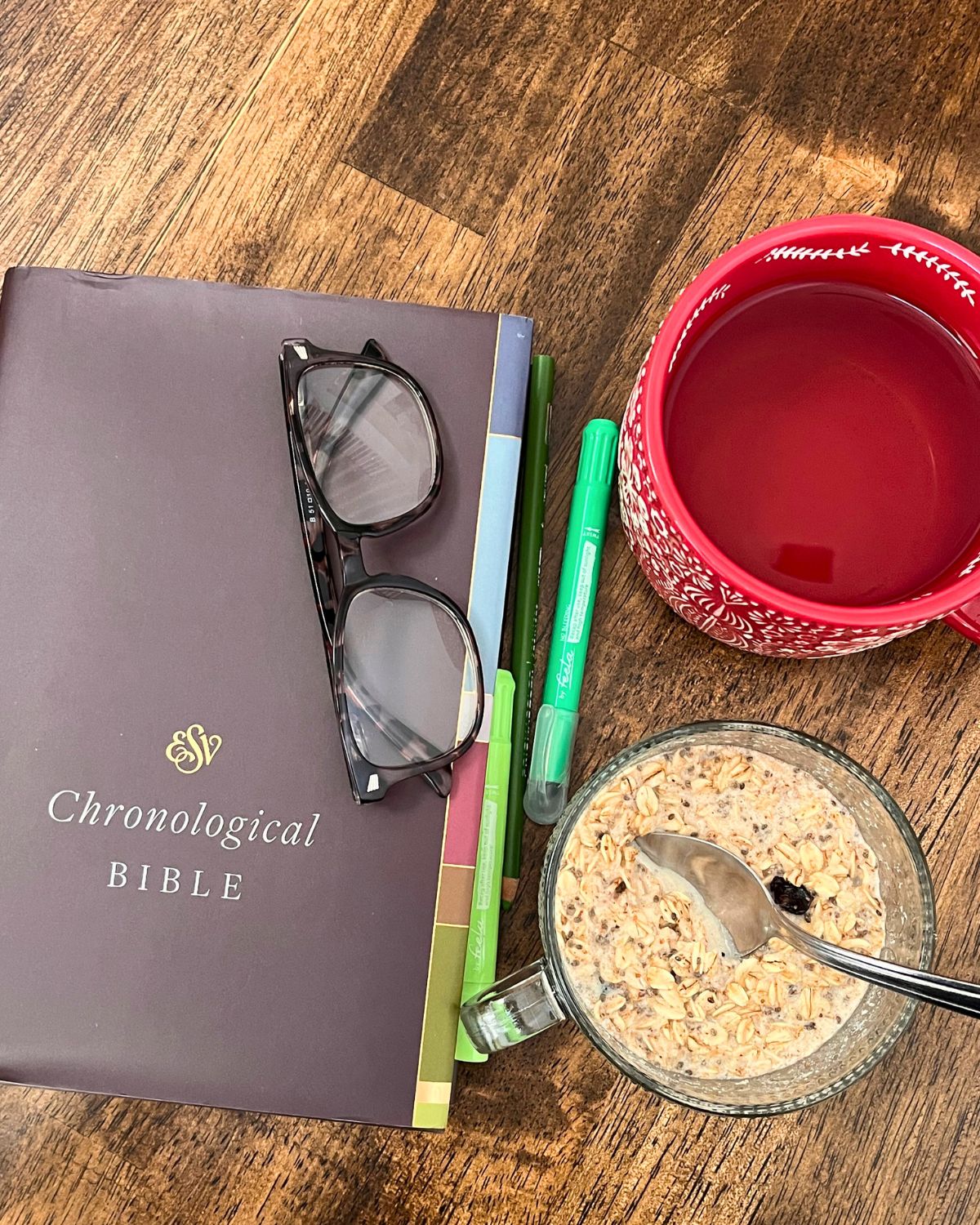 esv chronological bible, cup of tea, and bowl of oatmeal with highlighters.