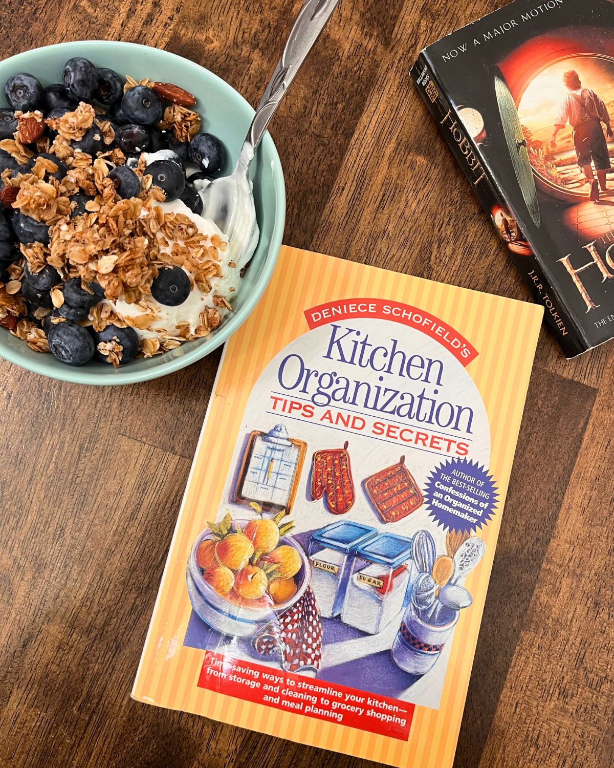berry yogurt parfait with books on table.