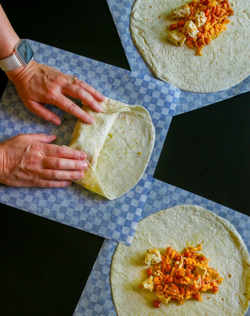 rolling the tortillas around the filling.