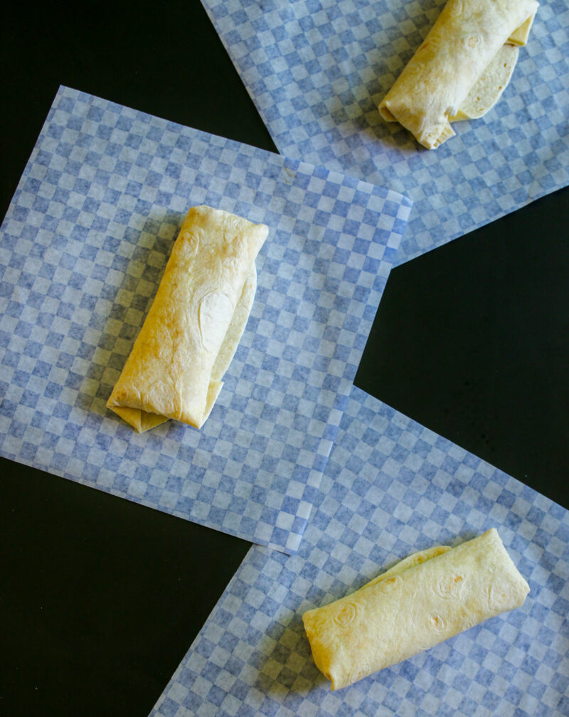 the rolled burritos on the deli papers.