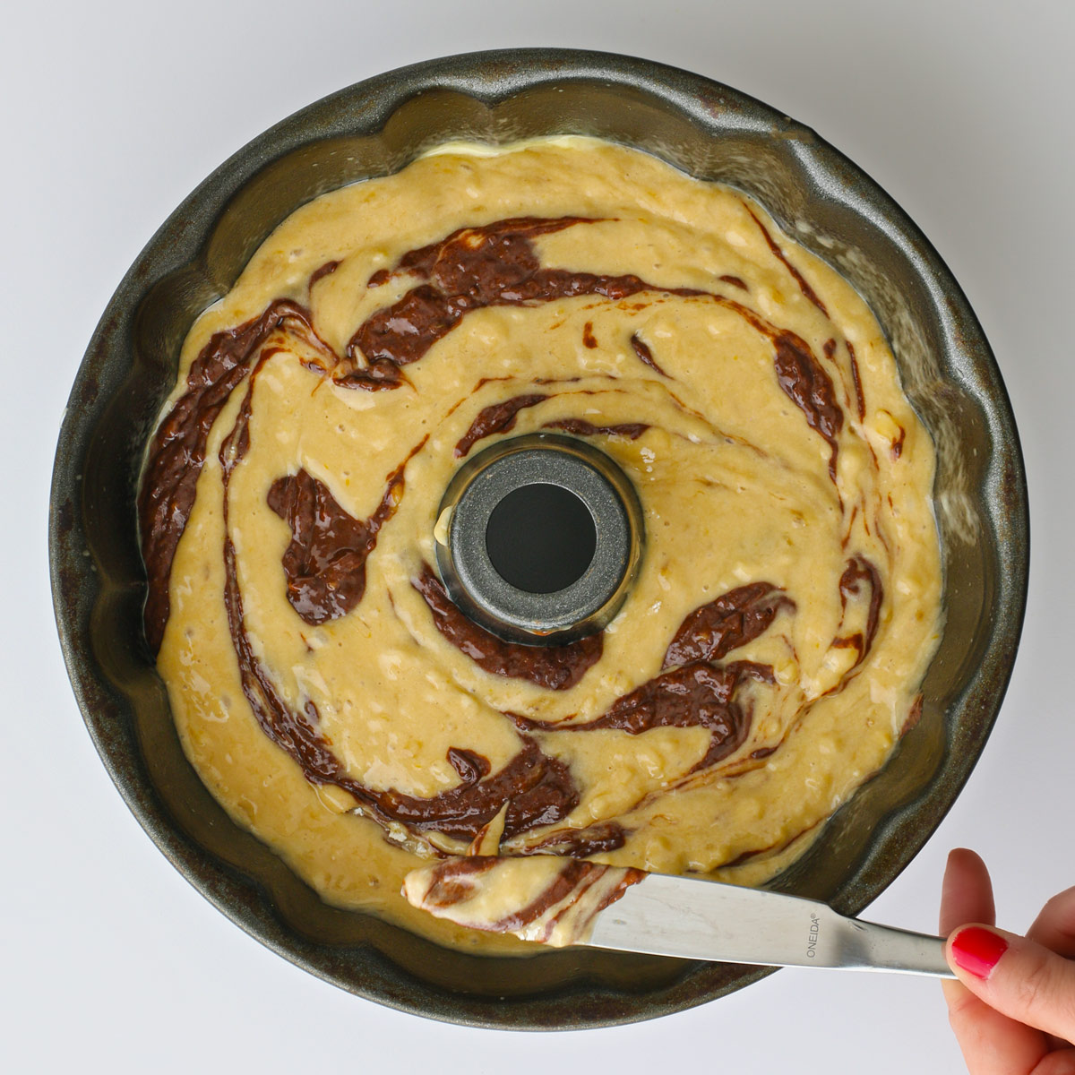 swirling the cake batters in the pan with a knife.