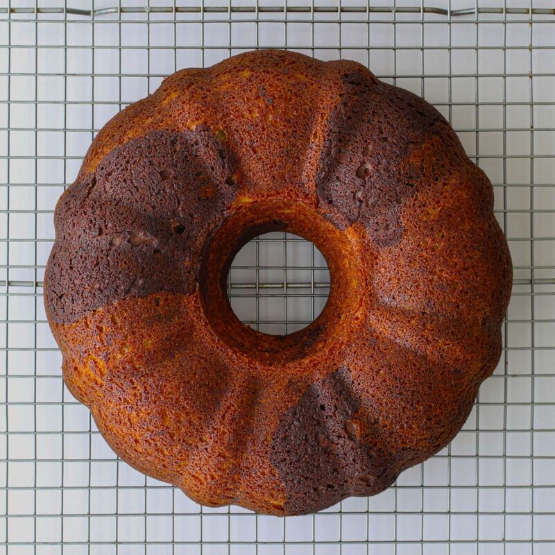 the baked cake cooling on a rack.