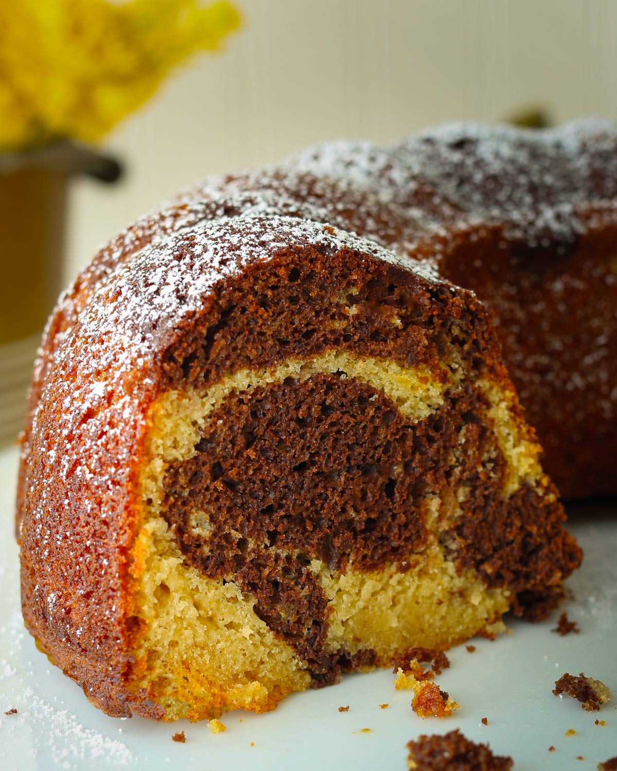 close up of banana cake with cut side showing marbled chocolate.