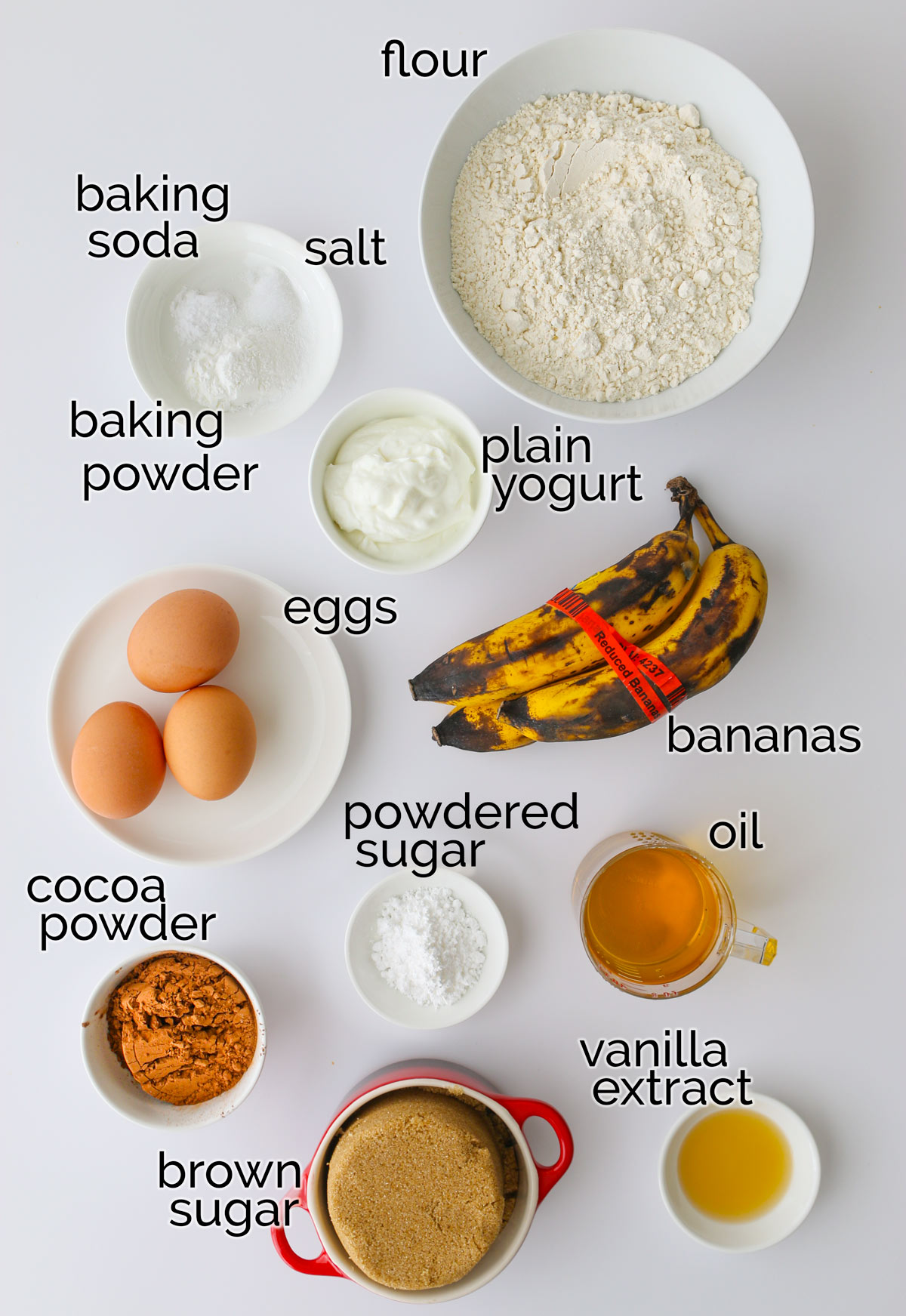 ingredients to make chocolate banana marble cake laid out on a white counter.