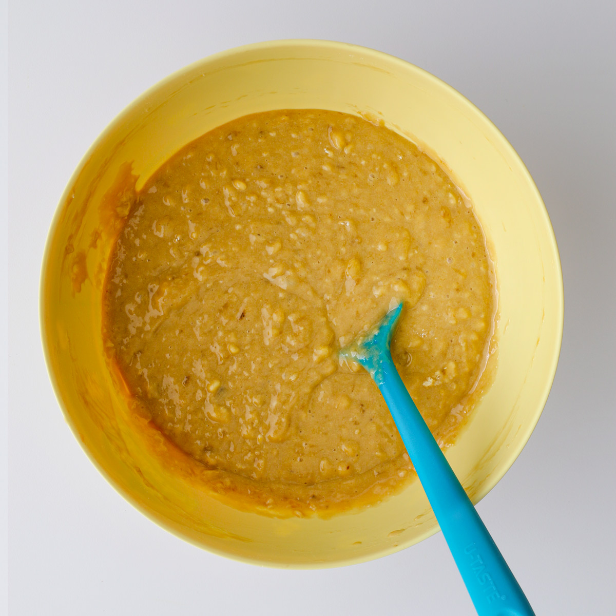 the banana cake batter in the yellow bowl.