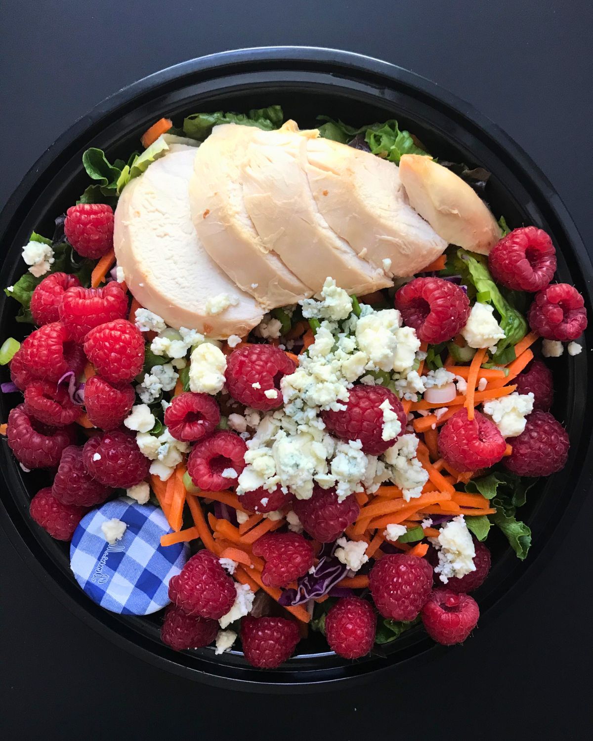 meal prep salad with rotisserie chicken and raspberries.
