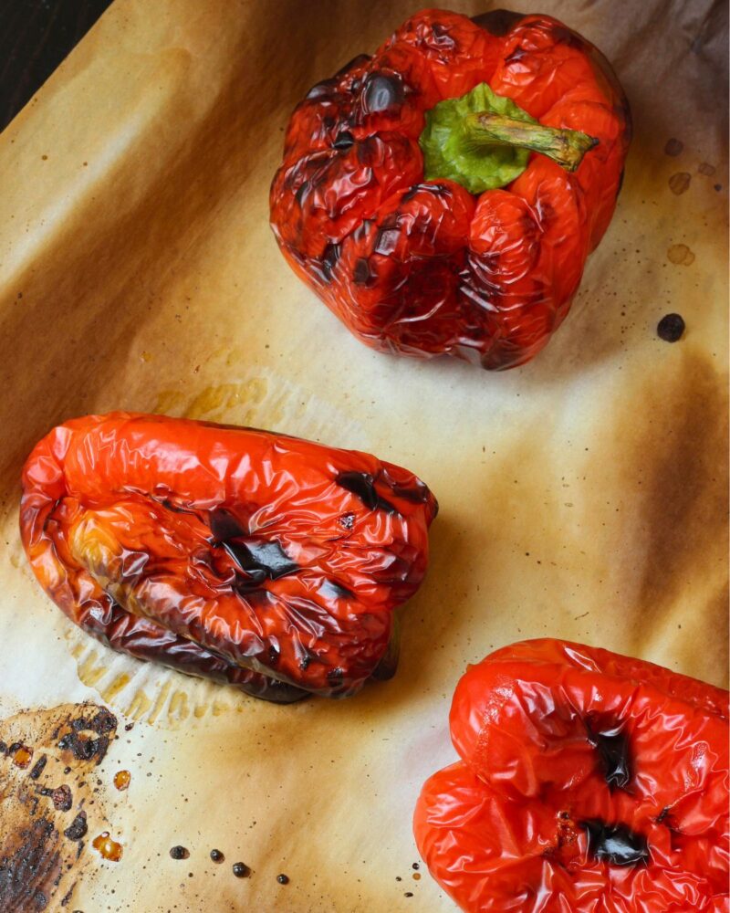 charred bell peppers on parchment.