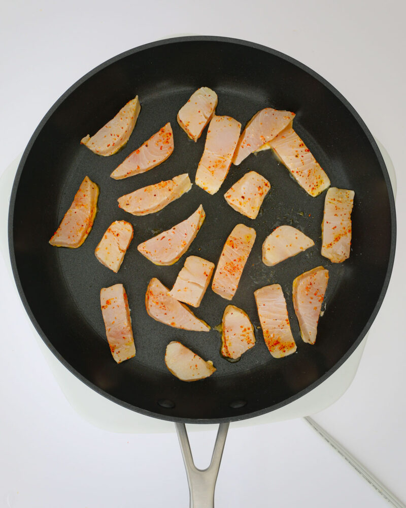 seasoned fish in the skillet.