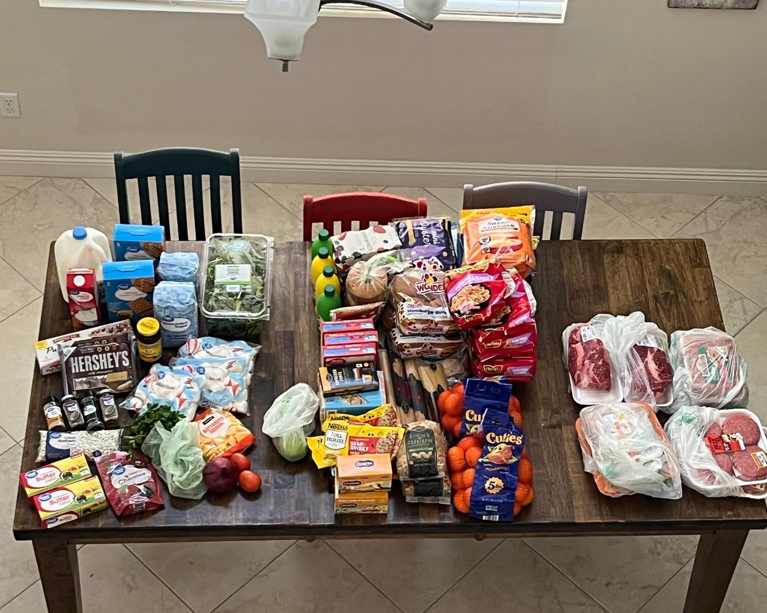 array of groceries laid out on wooden table.