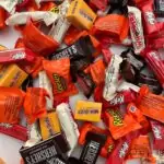 halloween candy scattered on white counter.