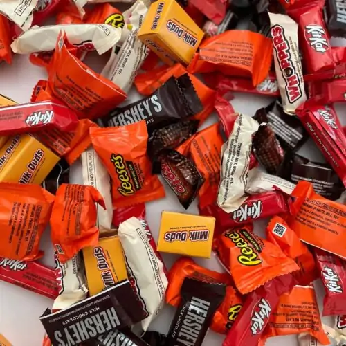 halloween candy scattered on white counter.