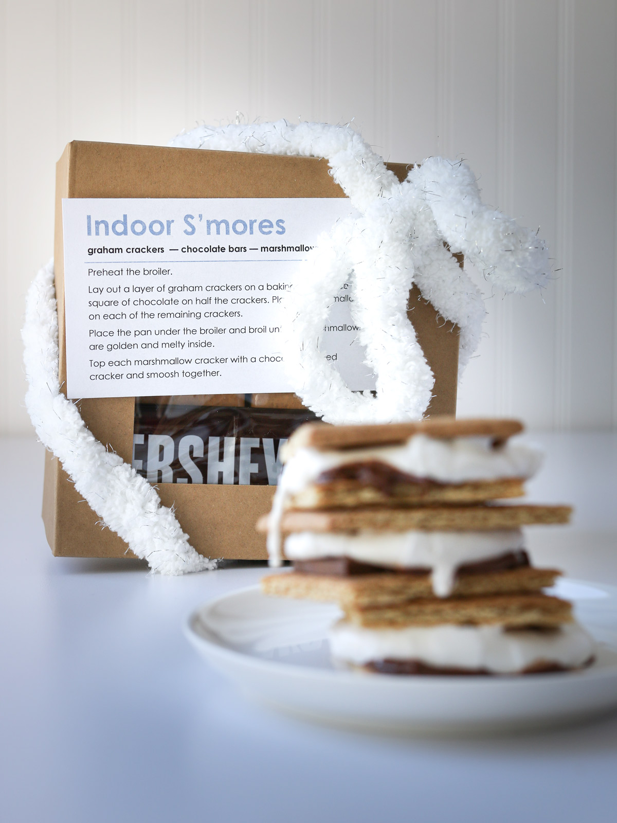 a wrapped s'mores kit next to a plate of prepped s'mores.
