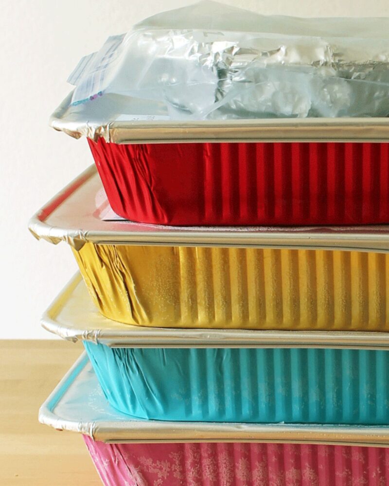 stacks of freezer meals in multi-colored pans.