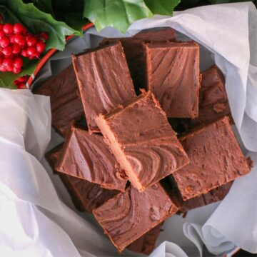 overhead shot of a christmas tin full of homemade fudge.