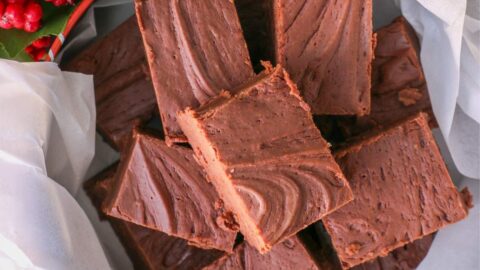 overhead shot of a christmas tin full of homemade fudge.