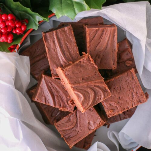 overhead shot of a christmas tin full of homemade fudge.