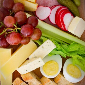 array of appetizer options on wooden board.