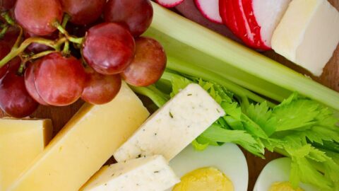 array of appetizer options on wooden board.