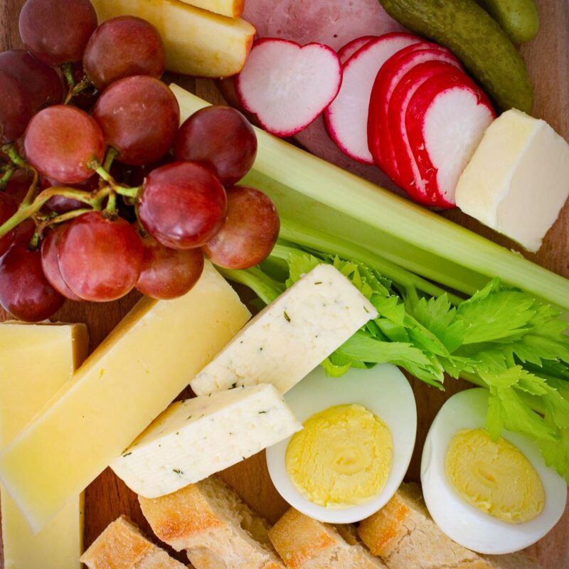array of appetizer options on wooden board.