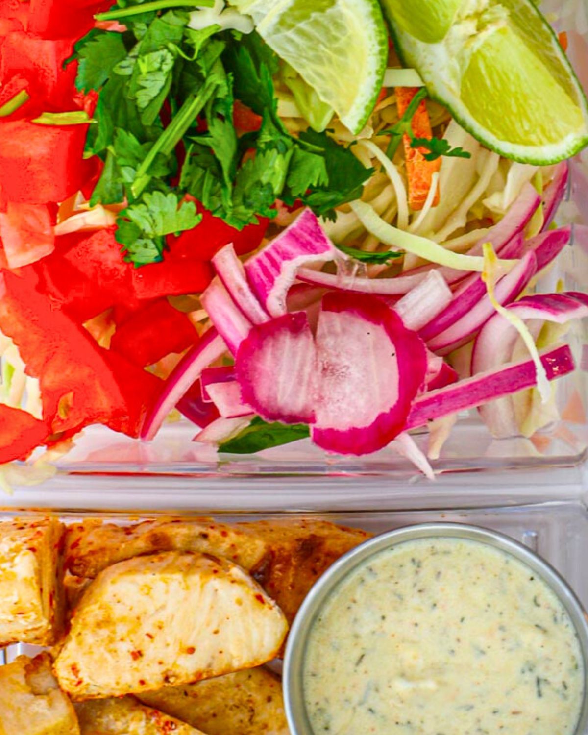 close up of bowl ingredients with pickled onions on top.