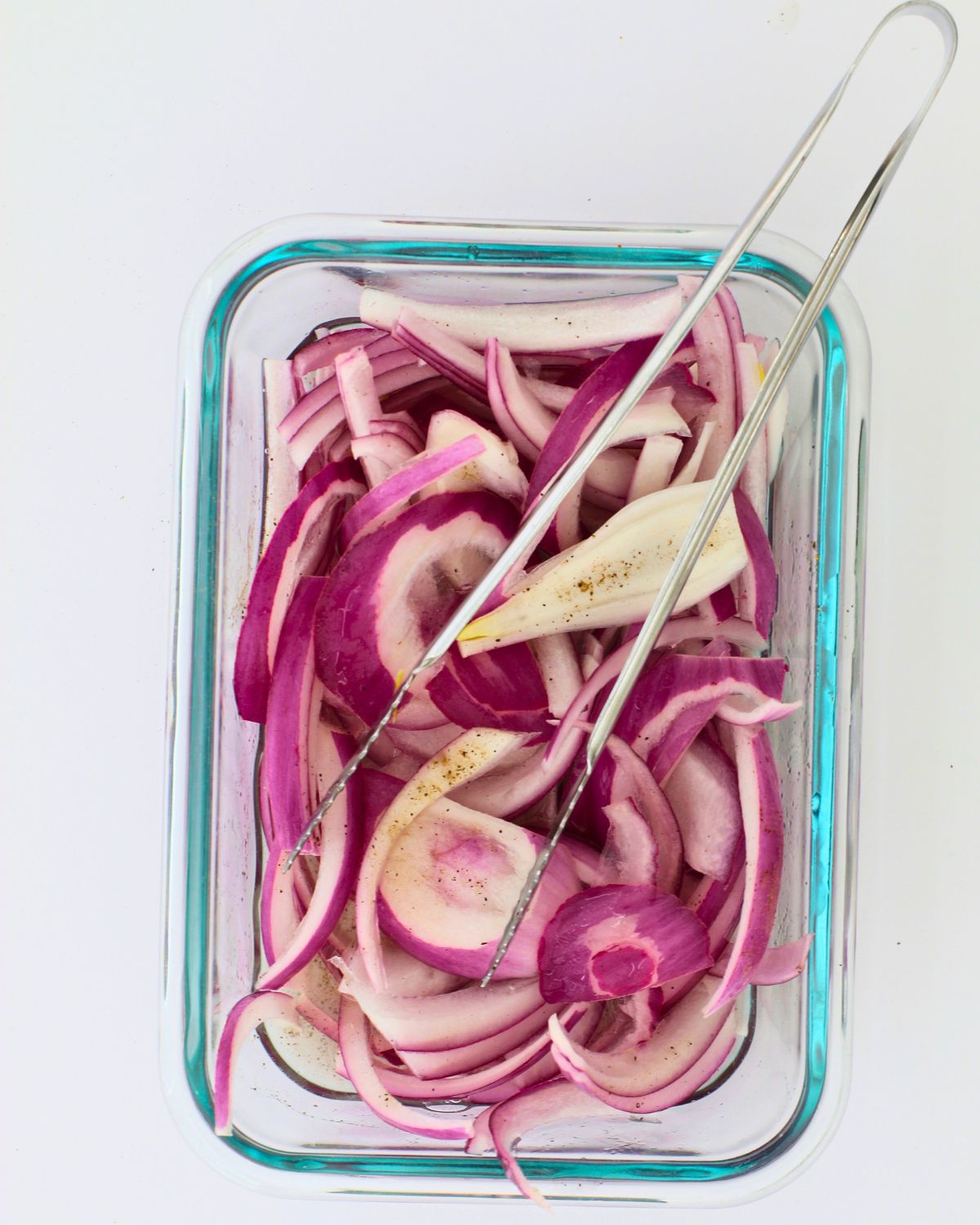 mixing onions with vinegar and spices.