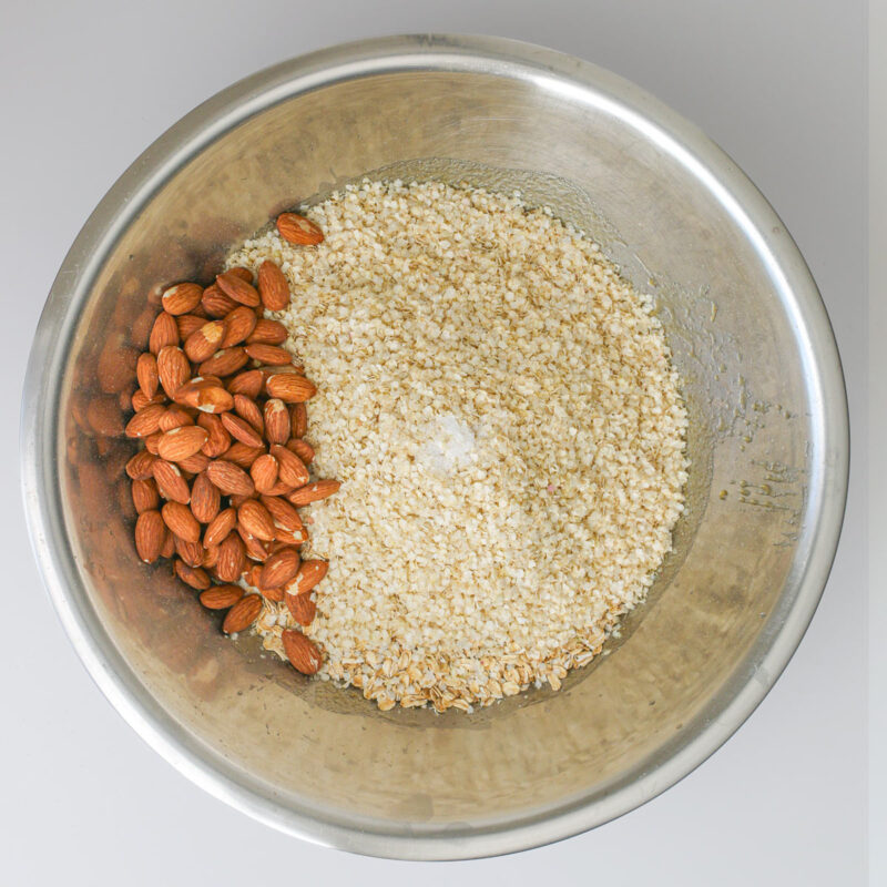 dry ingredients added to the wet ingredients in a stainless steel bowl.