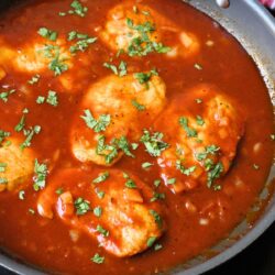 skillet full of pork chops in bbq sauce.