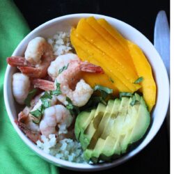 mango shrimp bowl with a green napkin.