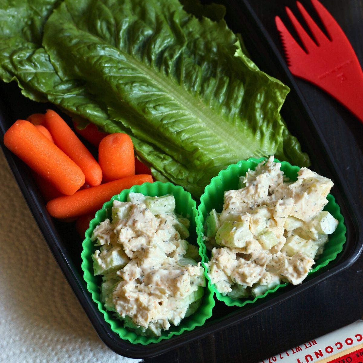 cajun chicken salad in silicone cups with lettuce leaves.