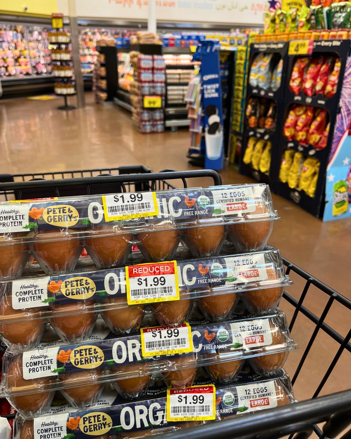 stack of clearanced egg cartons in cart in grocery store.