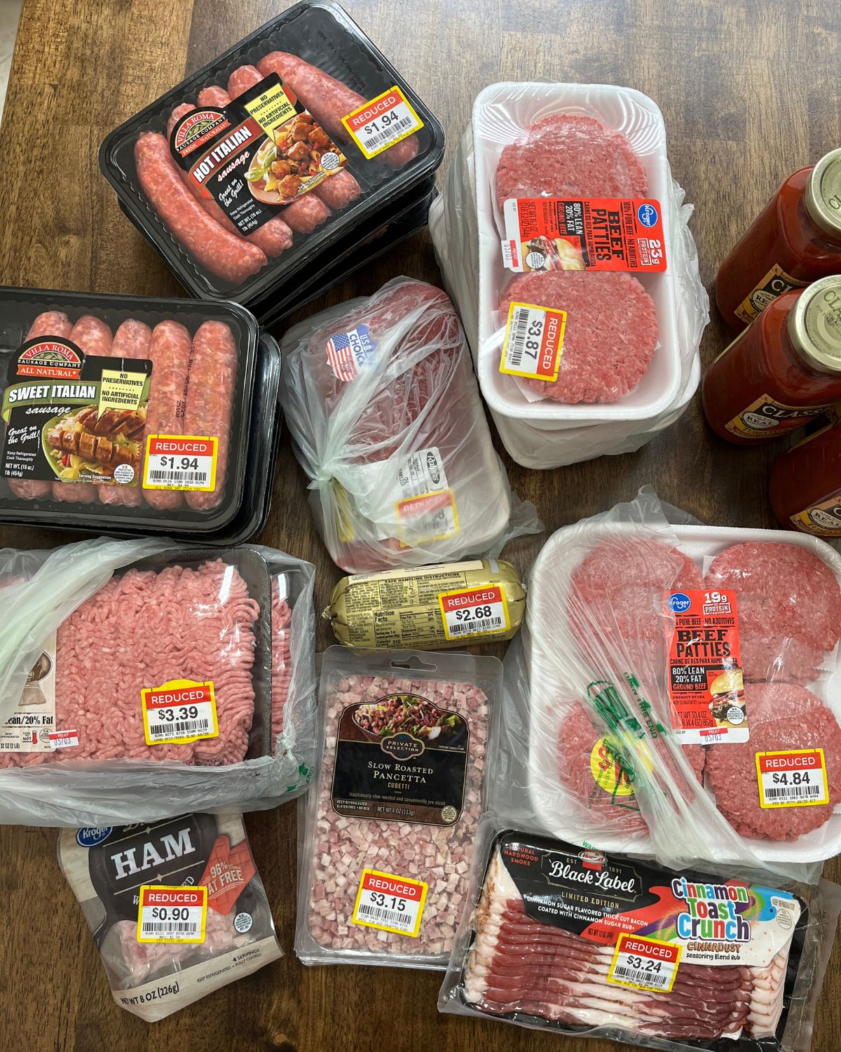 stacks of clearanced meat from ralphs on table.